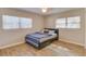 Bright bedroom featuring wood floors, natural light, and a blue and white striped bedspread at 1809 Pineview Cir, Winter Park, FL 32792