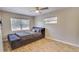 Cozy bedroom features a comfortable bed, natural lighting, and wood-look flooring at 1809 Pineview Cir, Winter Park, FL 32792