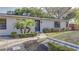 Charming single-story home with a landscaped front yard, healthy shrubbery, and inviting entryway at 1809 Pineview Cir, Winter Park, FL 32792