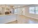 Bright kitchen featuring granite countertops, stainless steel appliances, and stylish white cabinetry at 1809 Pineview Cir, Winter Park, FL 32792