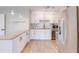 Modern kitchen featuring granite countertops, stainless steel appliances, and stylish white cabinetry at 1809 Pineview Cir, Winter Park, FL 32792