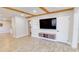 Bright living room featuring wood beam ceilings, a wall-mounted TV, and stylish flooring at 1809 Pineview Cir, Winter Park, FL 32792