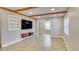 Open-concept living room with wood beams, tiled floors, and natural light at 1809 Pineview Cir, Winter Park, FL 32792