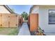 Private side yard with a concrete walkway and secure wood fence at 1809 Pineview Cir, Winter Park, FL 32792