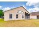 The home showcases windows, a screened patio, and a lawn that is spacious at 19756 Glen Elm Way, Orlando, FL 32833
