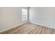 Well-lit bedroom with wood-look floors and a window with blinds for added privacy at 19756 Glen Elm Way, Orlando, FL 32833