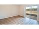 Bright bedroom featuring wood-look floors and sliding glass door to the screened patio at 19756 Glen Elm Way, Orlando, FL 32833