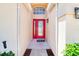 Welcoming front entry showcasing a bright red door with glass panels, leading into a light-filled home at 19756 Glen Elm Way, Orlando, FL 32833