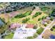 Aerial view of a golf course with winding greens, mature trees, and nearby homes at 19756 Glen Elm Way, Orlando, FL 32833
