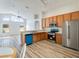 Bright kitchen featuring stainless steel appliances, wooden cabinets and breakfast bar overlooking the living area at 19756 Glen Elm Way, Orlando, FL 32833