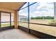 Covered lanai offers views of the expansive backyard and sunny blue skies at 19756 Glen Elm Way, Orlando, FL 32833