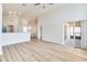 Spacious living room featuring wood-look floors, slider to patio, and open access to dining area at 19756 Glen Elm Way, Orlando, FL 32833