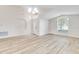 Bright, open living room with vaulted ceilings, large windows, and wood-look flooring at 19756 Glen Elm Way, Orlando, FL 32833