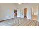 Open main bedroom with ensuite bathroom, walk-in closet, and modern wood-look flooring at 19756 Glen Elm Way, Orlando, FL 32833