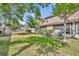 Backyard space with lush green lawn and mature trees, offering a serene outdoor setting at 212 Belvedere Way, Sanford, FL 32773