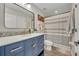 Stylish bathroom featuring modern vanity, black hardware, and striped shower curtain at 212 Belvedere Way, Sanford, FL 32773