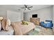 Cozy bedroom with ceiling fan, dresser, blue accent chair and closet at 212 Belvedere Way, Sanford, FL 32773