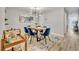 Dining room featuring a modern chandelier, blue chairs, and an adjacent bar cart at 212 Belvedere Way, Sanford, FL 32773