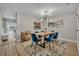 Dining room featuring a modern chandelier, blue chairs, and an adjacent bar cart at 212 Belvedere Way, Sanford, FL 32773
