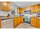 Well-lit kitchen featuring stainless steel appliances, wooden cabinets, and ample countertop space at 212 Belvedere Way, Sanford, FL 32773
