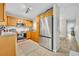 Bright kitchen featuring stainless steel appliances, wooden cabinets, and tile flooring at 212 Belvedere Way, Sanford, FL 32773