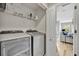 Convenient laundry room with washer, dryer, and shelving at 212 Belvedere Way, Sanford, FL 32773