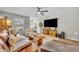 Bright living room with a large TV, comfortable seating, and stylish decor at 212 Belvedere Way, Sanford, FL 32773