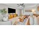 Inviting living room with a large TV, comfortable seating, and stylish decor at 212 Belvedere Way, Sanford, FL 32773