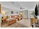 Bright living room with modern decor, stylish rug, and comfortable leather couch at 212 Belvedere Way, Sanford, FL 32773