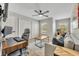 Cozy living room with modern furniture, ceiling fan, large window, and working space at 212 Belvedere Way, Sanford, FL 32773