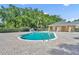 Community pool with a beautiful pool house surrounded by trees and chairs at 212 Belvedere Way, Sanford, FL 32773
