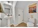 Stylish powder room featuring a pedestal sink, toilet, and neutral decor at 212 Belvedere Way, Sanford, FL 32773