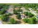 Aerial view of a residential property with lush surroundings, mature trees, and a long driveway at 21343 Reindeer Rd, Christmas, FL 32709