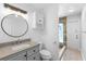 This bathroom features a granite-topped vanity and shower with a seamless glass door and custom tile at 21343 Reindeer Rd, Christmas, FL 32709