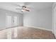 Bedroom with neutral walls, ceiling fan, and sliding glass doors leading to the backyard at 21343 Reindeer Rd, Christmas, FL 32709
