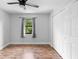 Bright bedroom with wood flooring, ceiling fan, natural light, and closet at 21343 Reindeer Rd, Christmas, FL 32709