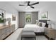 Bright bedroom features a ceiling fan, neutral decor and plush bedding, offering a comfortable and inviting atmosphere at 21343 Reindeer Rd, Christmas, FL 32709