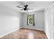 Bedroom featuring wood floors, fan, and closet at 21343 Reindeer Rd, Christmas, FL 32709