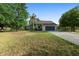 Beautiful single-story home with a well-manicured lawn, palm tree, and a two-car garage, perfect for Gathering living at 21343 Reindeer Rd, Christmas, FL 32709