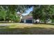 Lovely home with a well-manicured lawn and a long driveway leading to the attached garage at 21343 Reindeer Rd, Christmas, FL 32709