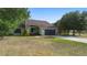 Charming single-story home with a well-maintained lawn, two-car garage, and appealing exterior at 21343 Reindeer Rd, Christmas, FL 32709
