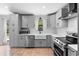 The kitchen has stainless steel appliances, light grey cabinets and white counter tops, and a window view to the outside at 21343 Reindeer Rd, Christmas, FL 32709