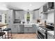Well-equipped kitchen features modern appliances, stylish cabinets, a farmhouse sink, and ample counter space at 21343 Reindeer Rd, Christmas, FL 32709