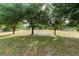 Large grass-covered lot with mature trees at this home site at 21343 Reindeer Rd, Christmas, FL 32709