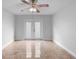 Bright living room featuring tile floors, ceiling fan, and glass doors at 21343 Reindeer Rd, Christmas, FL 32709
