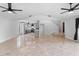 Spacious living room with kitchen view, offering tile flooring and natural light throughout the home at 21343 Reindeer Rd, Christmas, FL 32709
