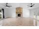 Spacious living room boasts a stone fireplace, ceiling fans, and sliding glass doors to the backyard at 21343 Reindeer Rd, Christmas, FL 32709