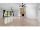 Bright living room features a stone fireplace, neutral walls, ceiling fans, and a large window at 21343 Reindeer Rd, Christmas, FL 32709