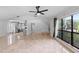 Bright, open-concept space shows living room, kitchen, stairs, and large windows to the backyard at 21343 Reindeer Rd, Christmas, FL 32709