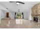 Open living area with tile floors, fireplace, decorative front door and large windows with backyard views at 21343 Reindeer Rd, Christmas, FL 32709